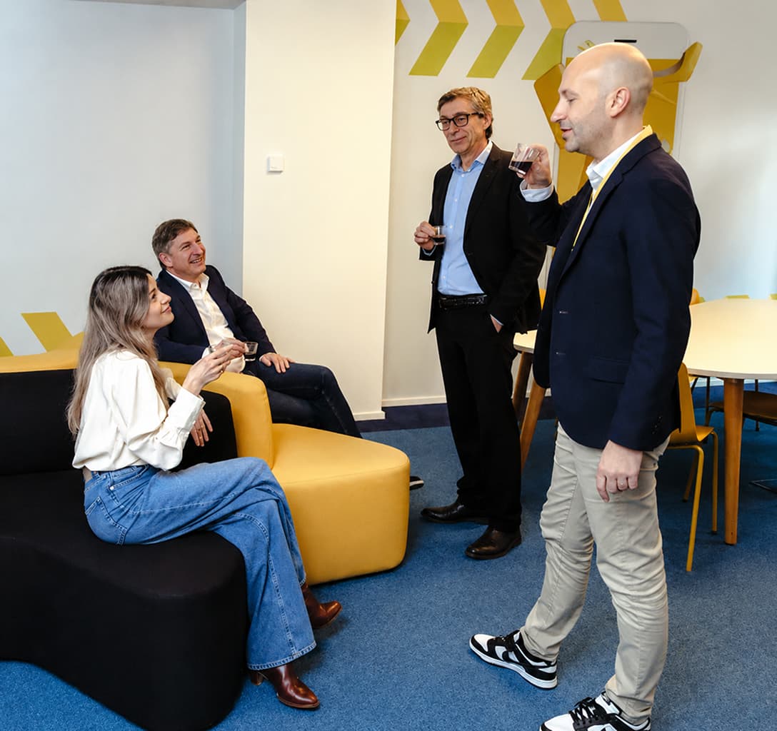 Aptean team members collaborating in a workplace lounge area