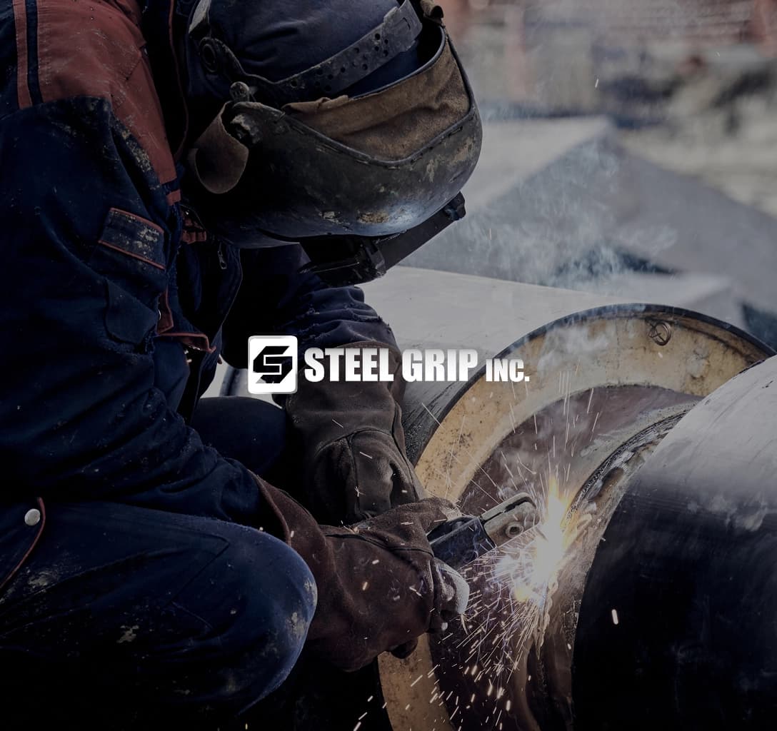 Steel Grip logo with a background showing a factory worker welding metal