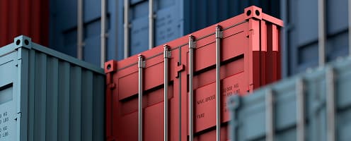 Stacked shipping containers in logistics yard close-up