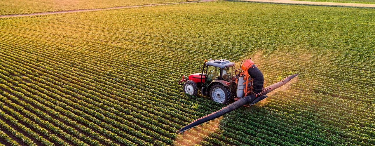 Tractor in field growing crops