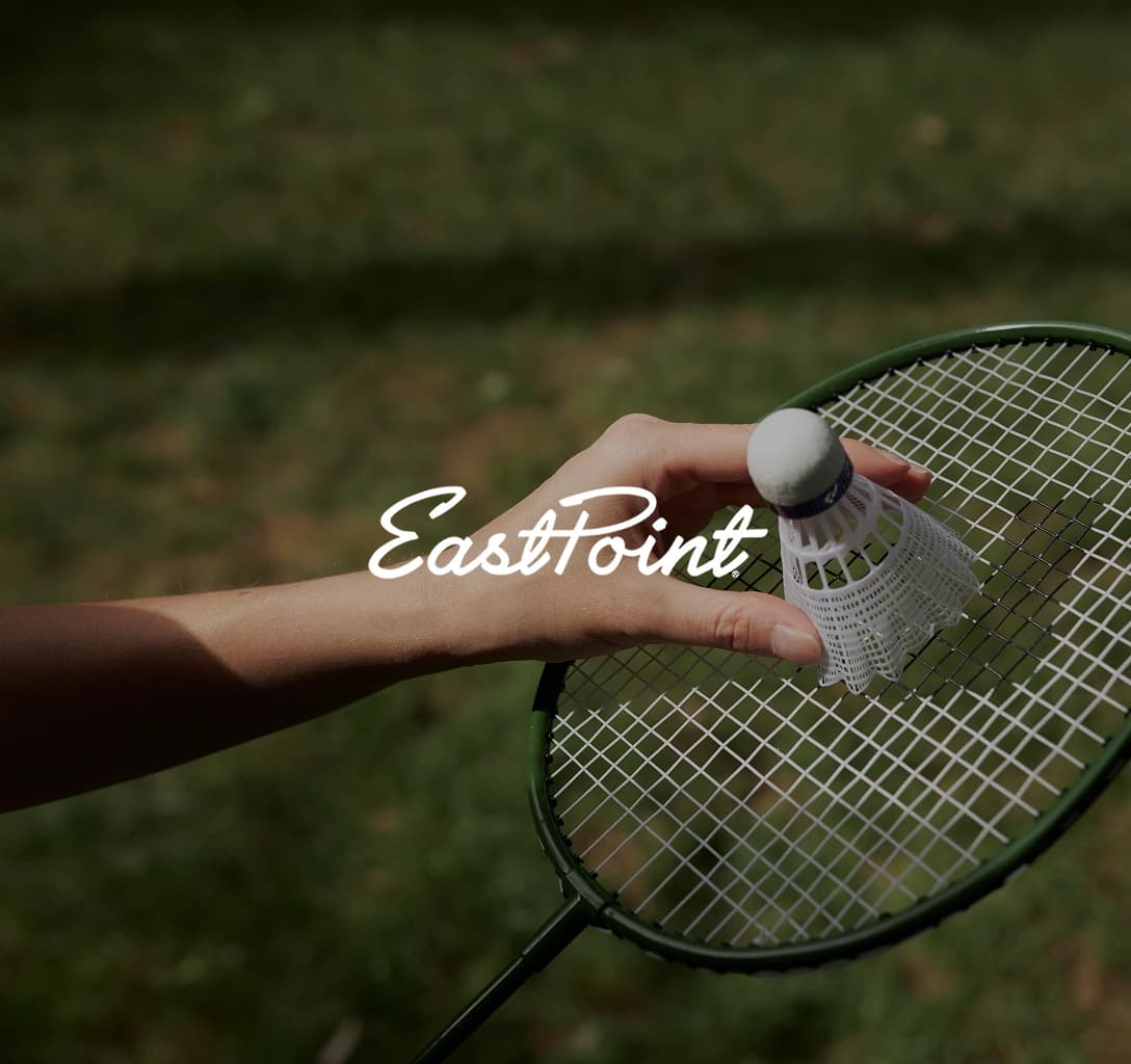 The EastPoint Sports logo, featuring a background of two hands holding a badminton racket and shuttlecock.