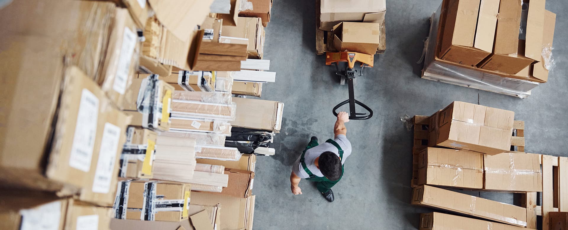 Warehouse worker moving boxes with Aptean Advanced Workflow solutions