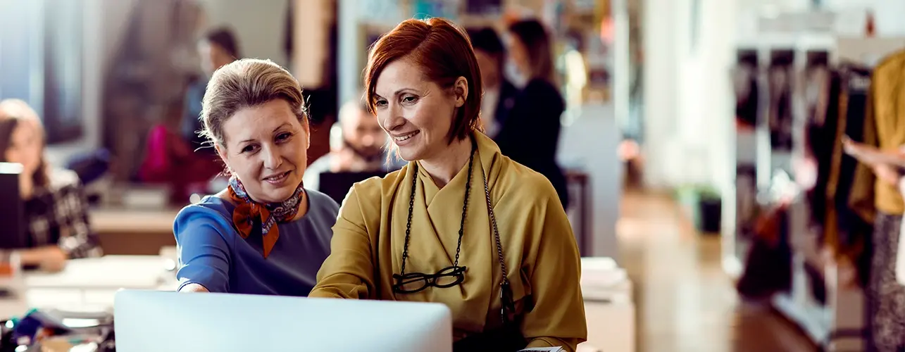 Workplace optimization two women checking possibilities in fashion