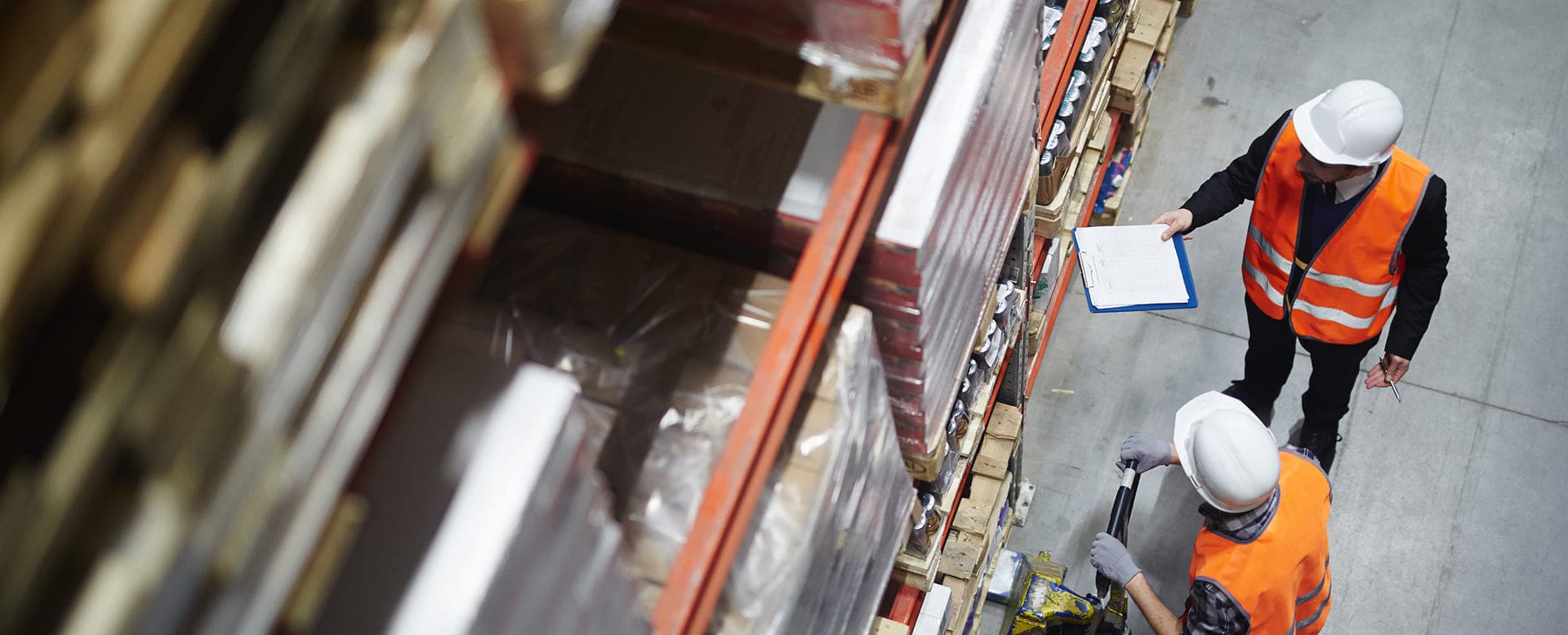 Warehouse workers reviewing inventory from above